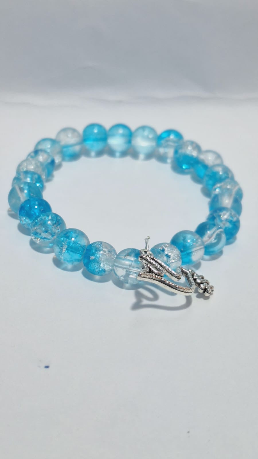 bracelets Multiple beaded, each with distinct colors and charms.