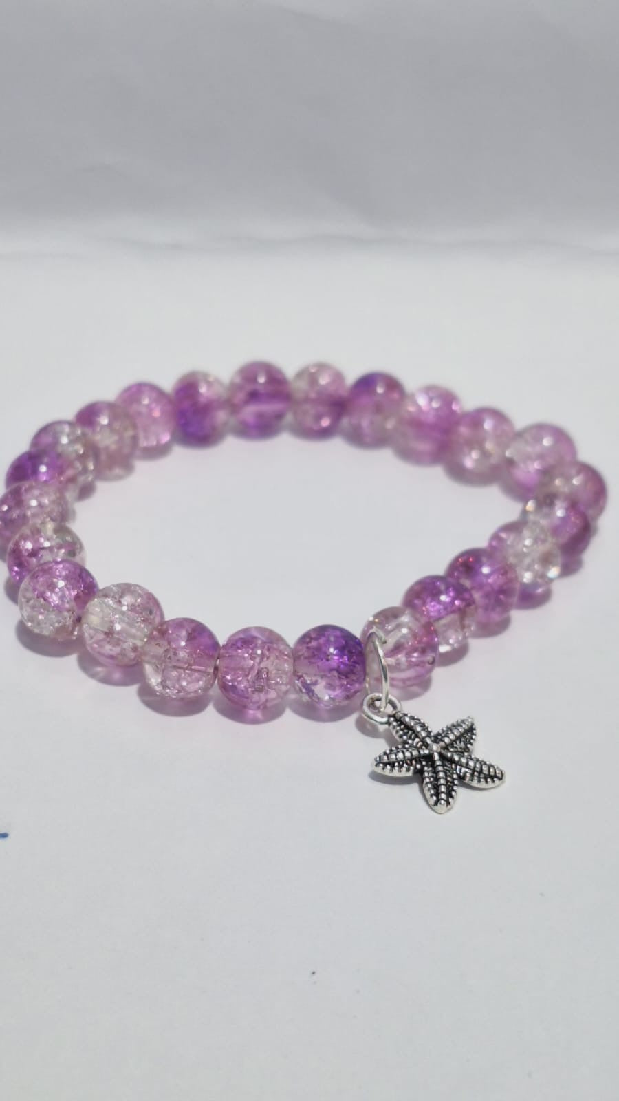 bracelets Multiple beaded, each with distinct colors and charms.