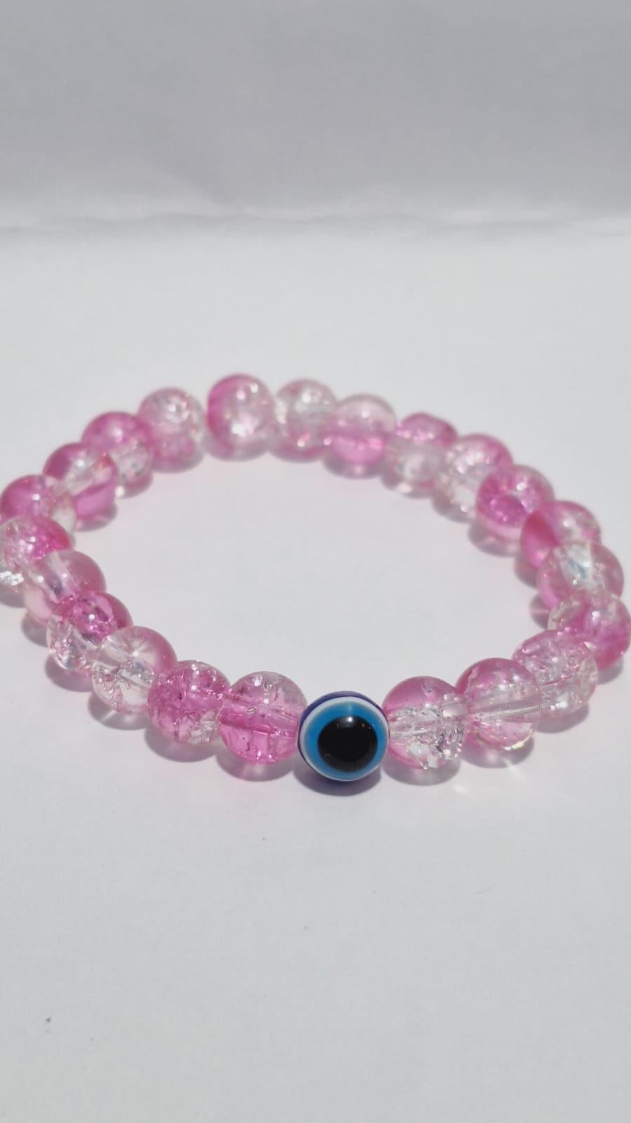 bracelets Multiple beaded, each with distinct colors and charms.