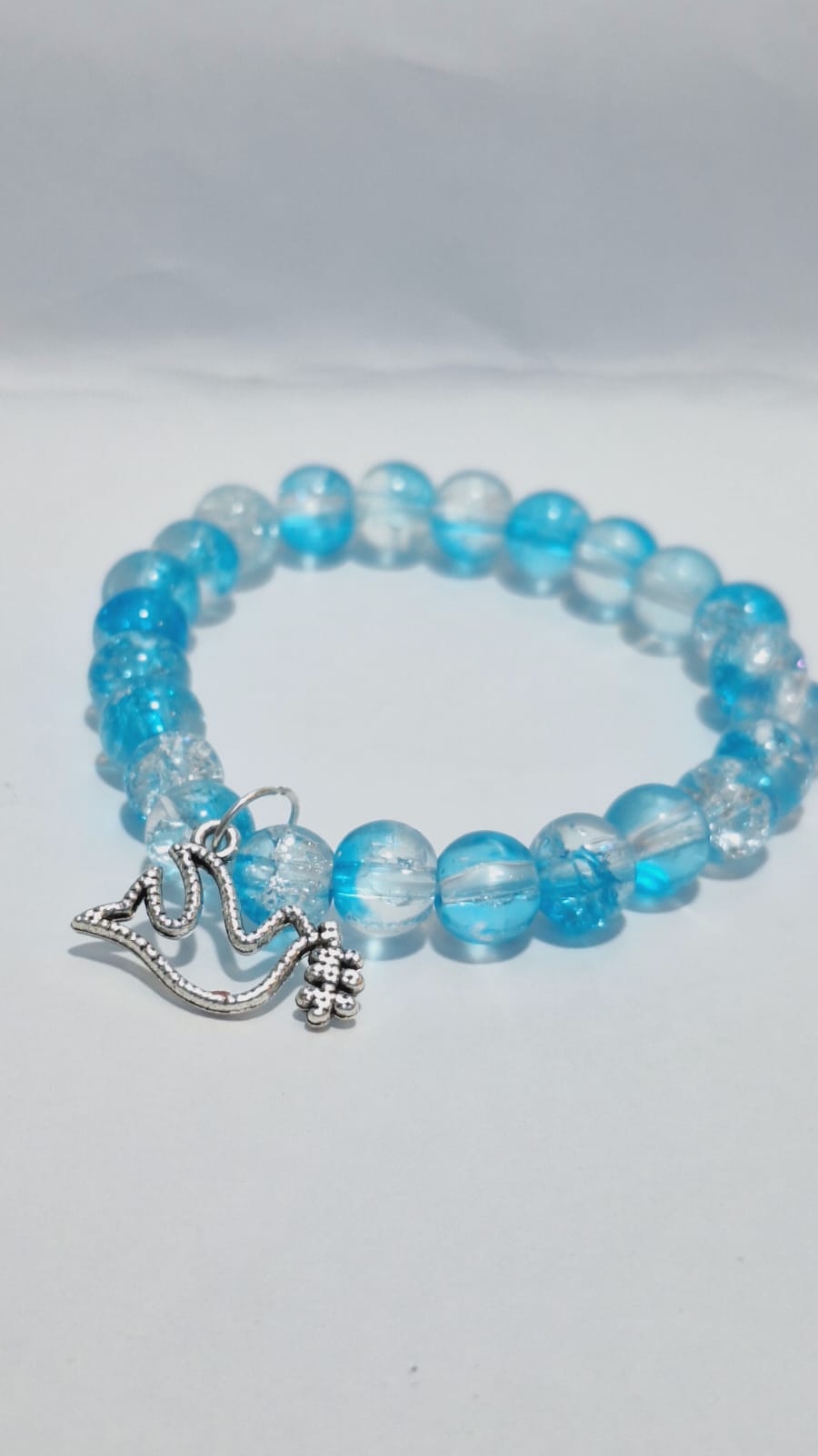 bracelets Multiple beaded, each with distinct colors and charms.