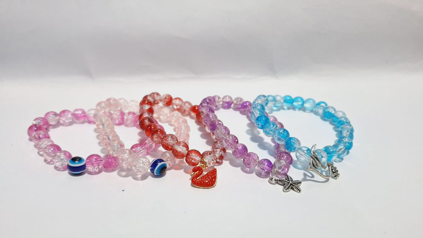 bracelets Multiple beaded, each with distinct colors and charms.