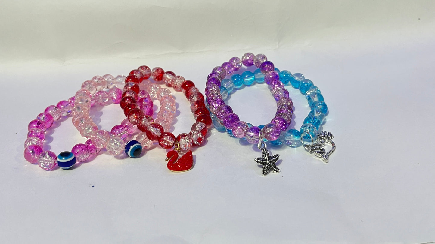 bracelets Multiple beaded, each with distinct colors and charms.
