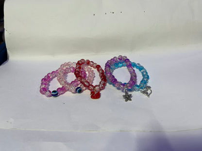 bracelets Multiple beaded, each with distinct colors and charms.