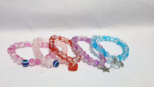 bracelets Multiple beaded, each with distinct colors and charms.