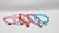 bracelets Multiple beaded, each with distinct colors and charms.