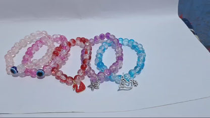 bracelets Multiple beaded, each with distinct colors and charms.
